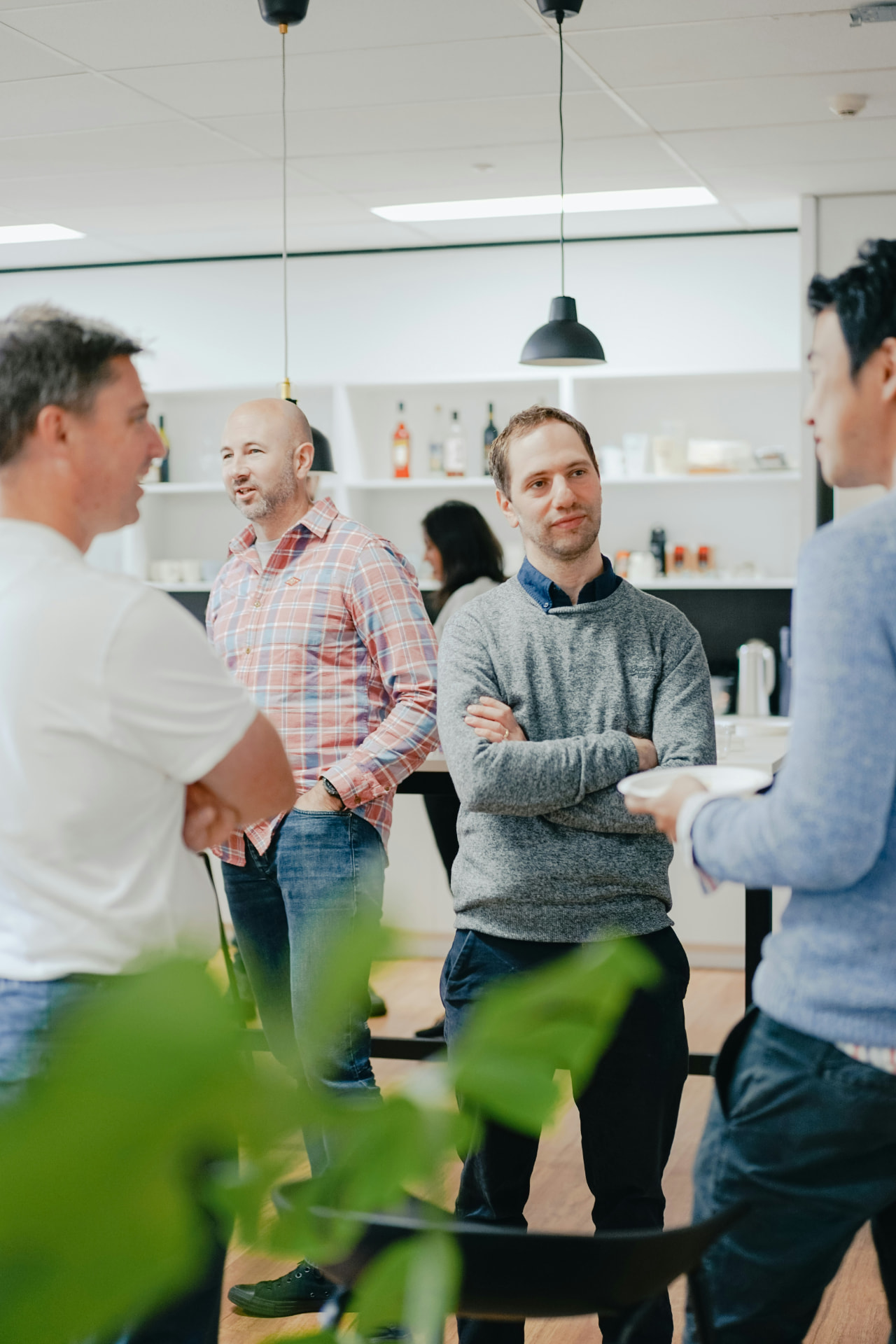 Business professionals talking together in a bright Wichita office