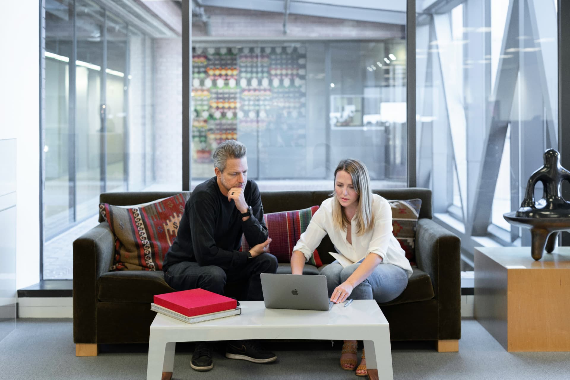 Mortgage broker and real estate professional reviewing documents together in a Wichita office